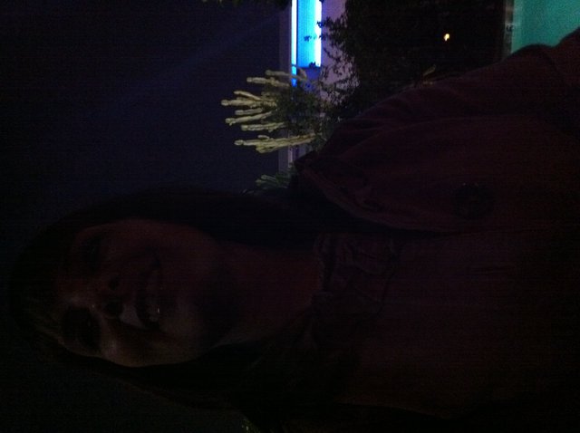 Woman Gazing Upward by Illuminated Pool at Night