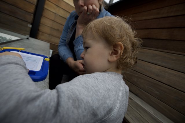 Tender Moment Between Parent and Child on Wooden Deck