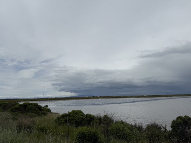 Tranquil Waters Under a Clouded Sky