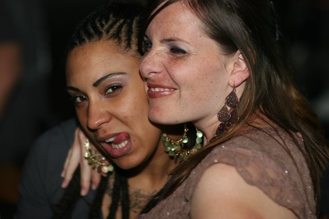 Two Friends Sharing a Joyful Moment at Nightclub
