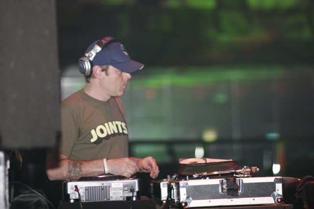 Hat-wearing Deejay Spins at Outdoor Concert