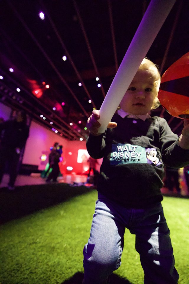 Toddler with Light Sword at Baby Rave Event