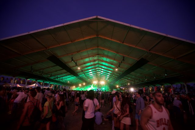 Nighttime Concert Crowd Under Urban Tent