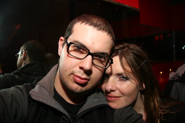 Couple Poses Close Together at Nightclub Event