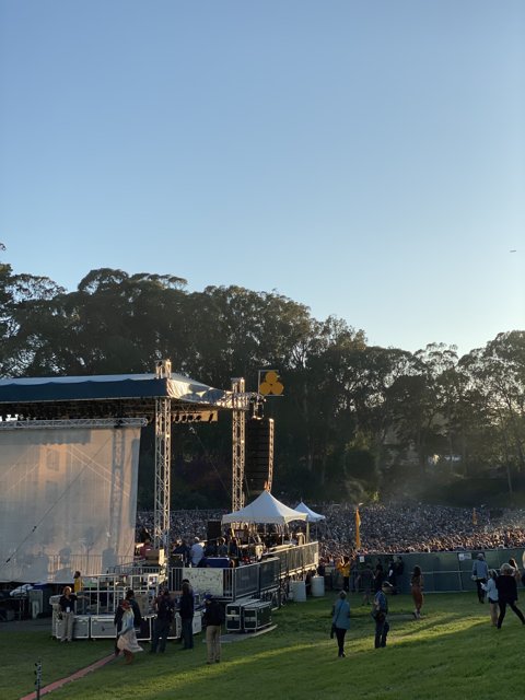 Concert Crowd Gathers Under Blue Skies