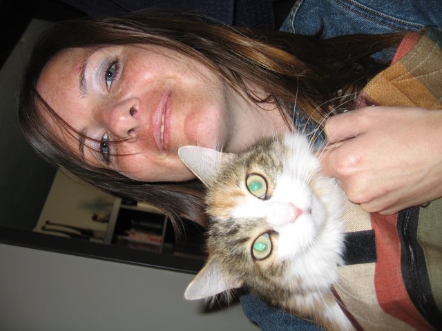 Woman and Her Green-Eyed Calico Cat Portrait