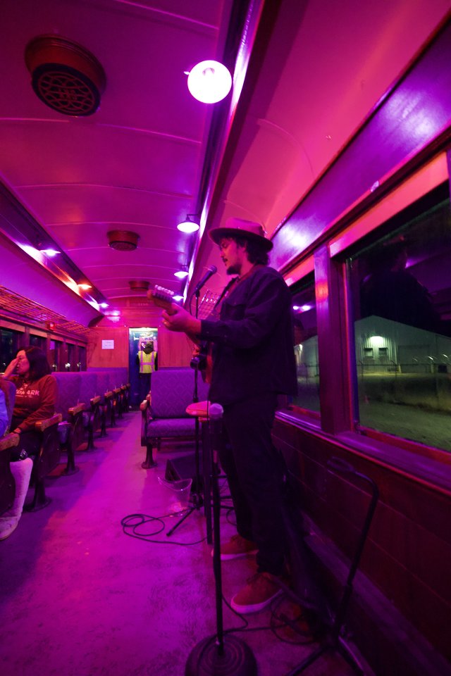 Live Music Performance in Vintage Purple-Lit Train Car