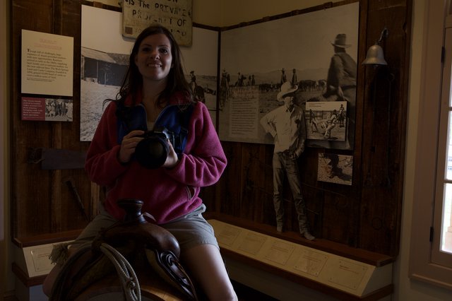 Young Woman Sits on Saddle in Western Ranch Museum