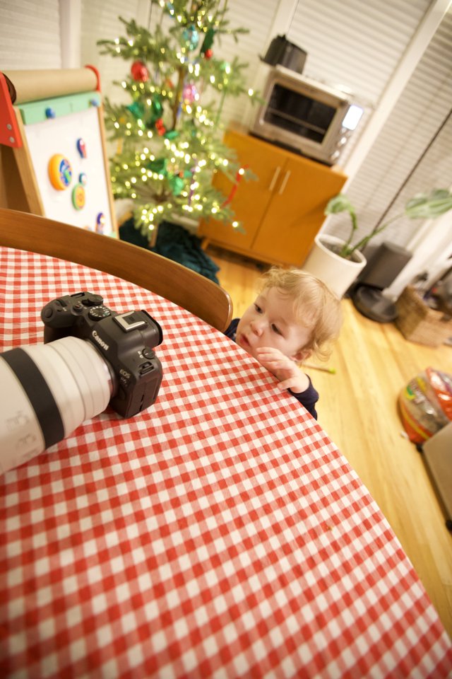 Curious Toddler Inspects Camera on Christmas Morning