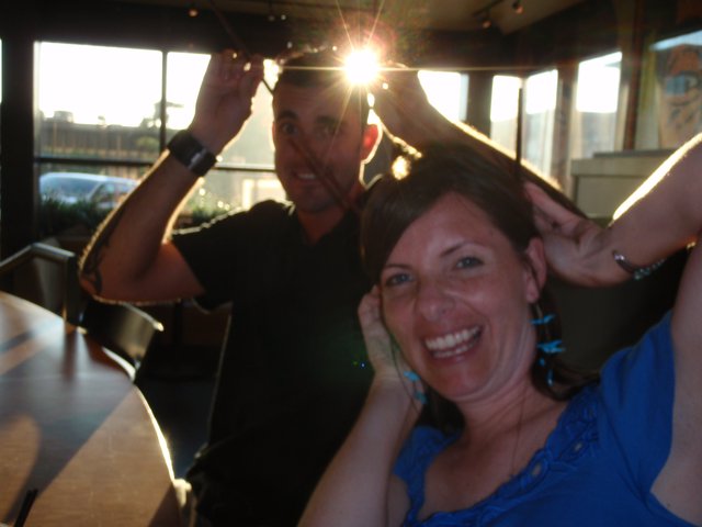 Friends Laughing Together at Sunset Restaurant