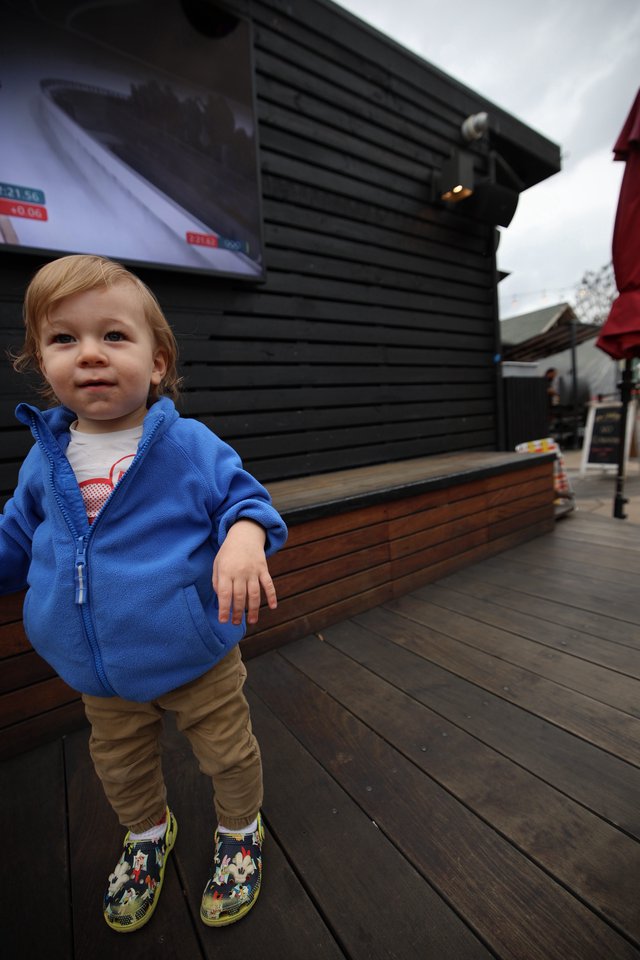Toddler in Blue Hoodie at Outdoor Venue