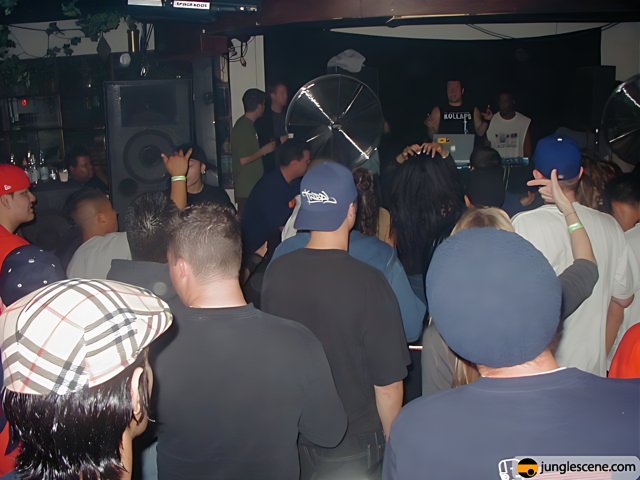 Partygoers Grooving to the Beat with a Baseball Cap Dude