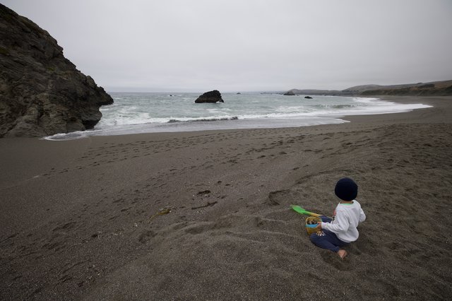 Solitary Child Gazing at the Pacific Ocean Shore