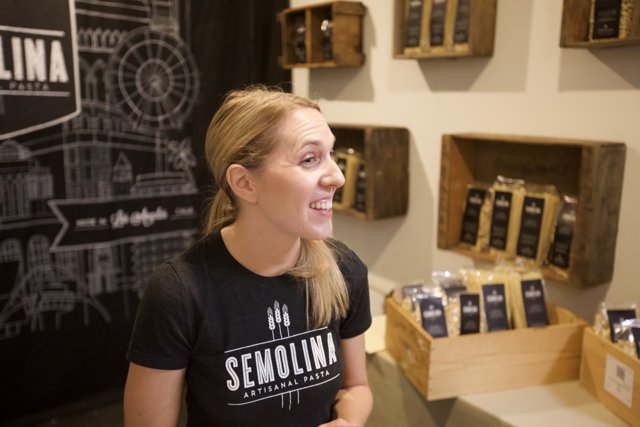 Smiling Woman with Coffee Display