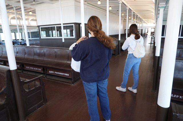 Visitors Exploring Historic Ship Interior Display