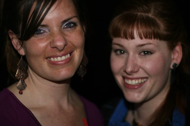 Two Smiling Women at a Nighttime Social Event