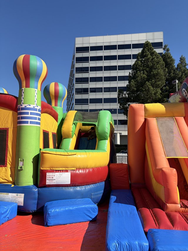 Colorful Inflatable Bounce House Complex at Urban Event