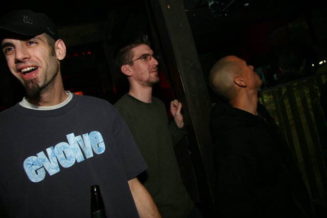 Three Men Enjoying a Night Out at a Bar