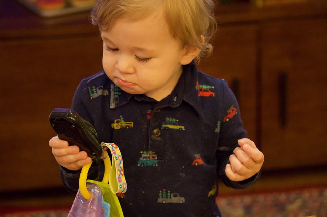Toddler Exploring Vegetables with Curious Expression