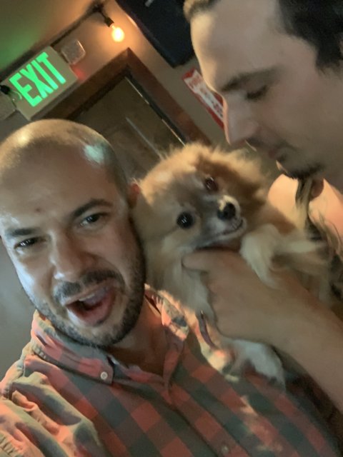 Two friends and a furry companion at the bar