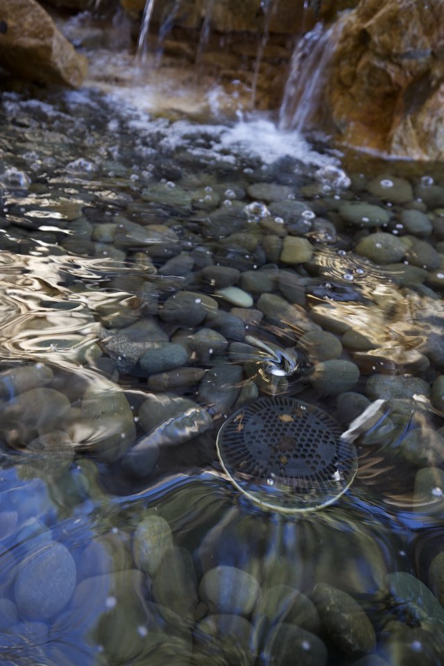 Rippling Stream Over Smooth River Stones