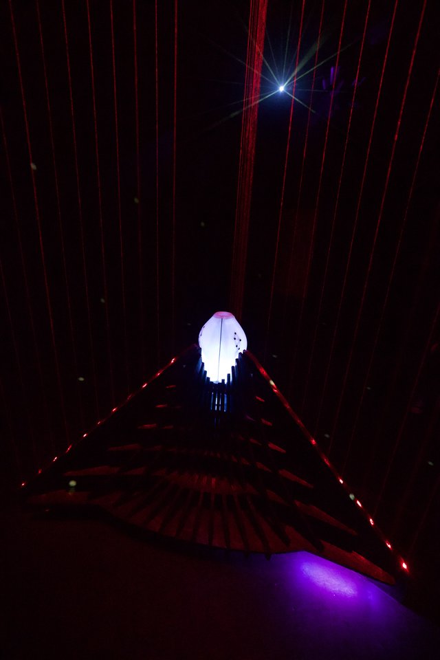 Illuminated Art Installation with Red Laser Beams