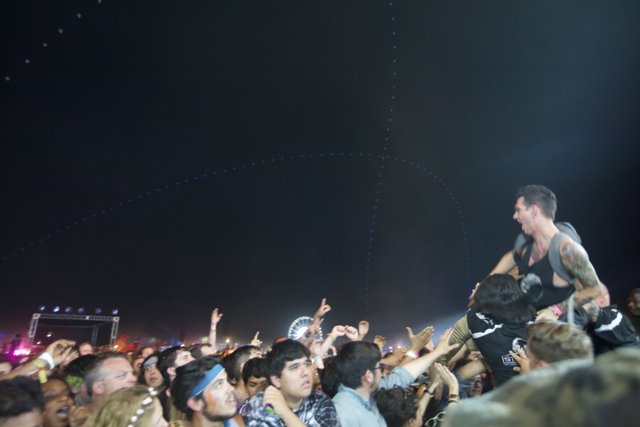 Man Riding the Crowd at Coachella Concert