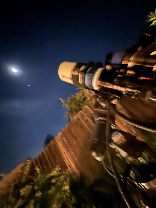 Telescope Observation Under Crescent Moon and Venus