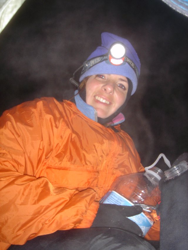 Smiling Climber Resting in Tent at Night