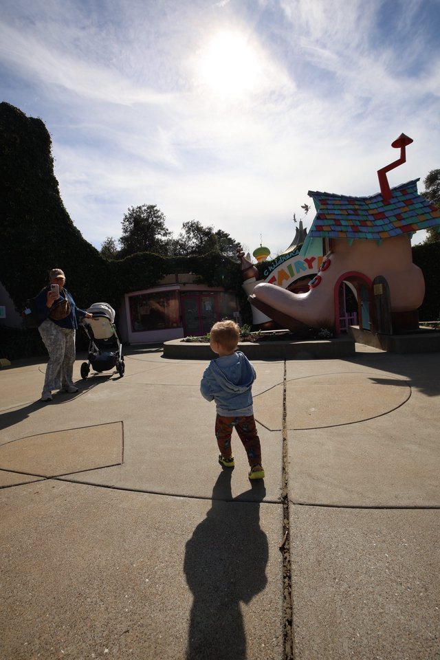Child Exploring Whimsical Toontown at Theme Park