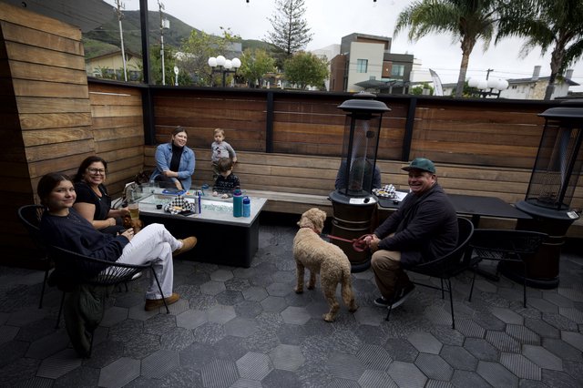 Family Gathering Around Patio Fire Pit at Dusk