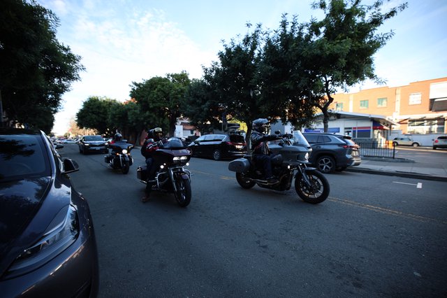 Motorcyclists Cruising Through Evening Urban Street