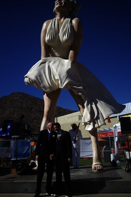 Clive Palmer posing with statue of woman in dress