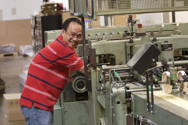 Happy Worker in a Busy Factory