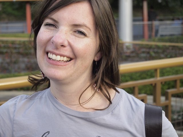 Joyful Woman Laughing Outdoors at Urban Park
