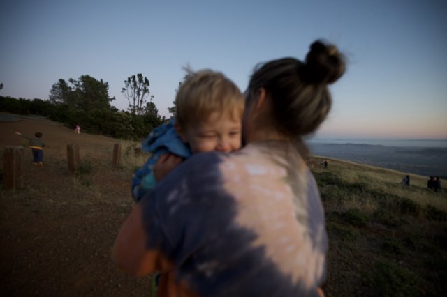 Mother and Child Embrace at Twilight Hilltop