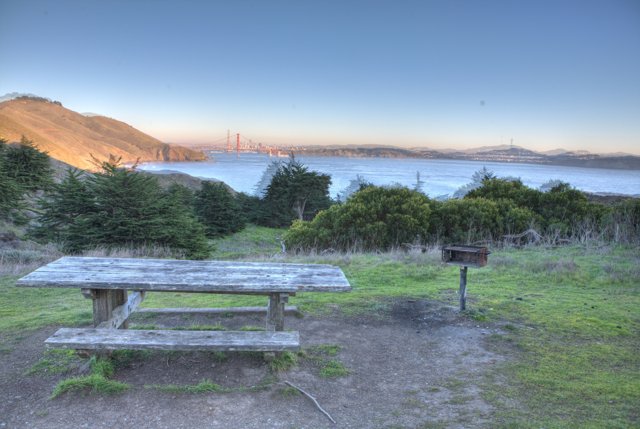 Serene View of Golden Gate Bridge from a Picnic Table on a Hill