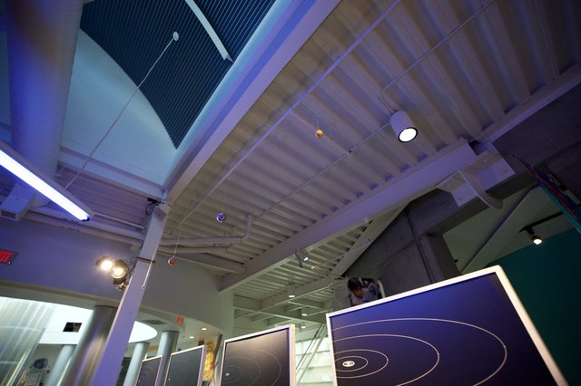 Modern Science Museum Interior with Orbital Display Panels