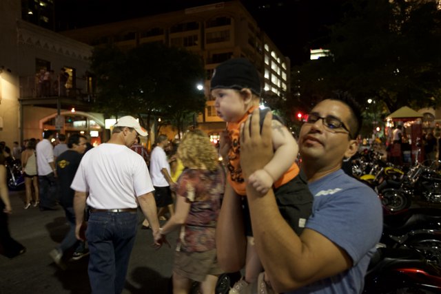 Nighttime Crowd with Father and Child