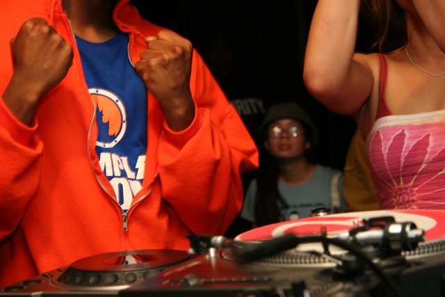 Red-Hooded DJ Spins the Night Away
