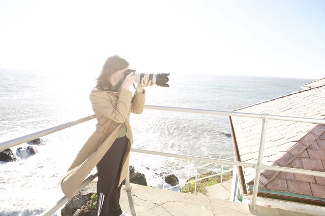 Photographer Capturing the Pacific Coast from Cliff's Edge
