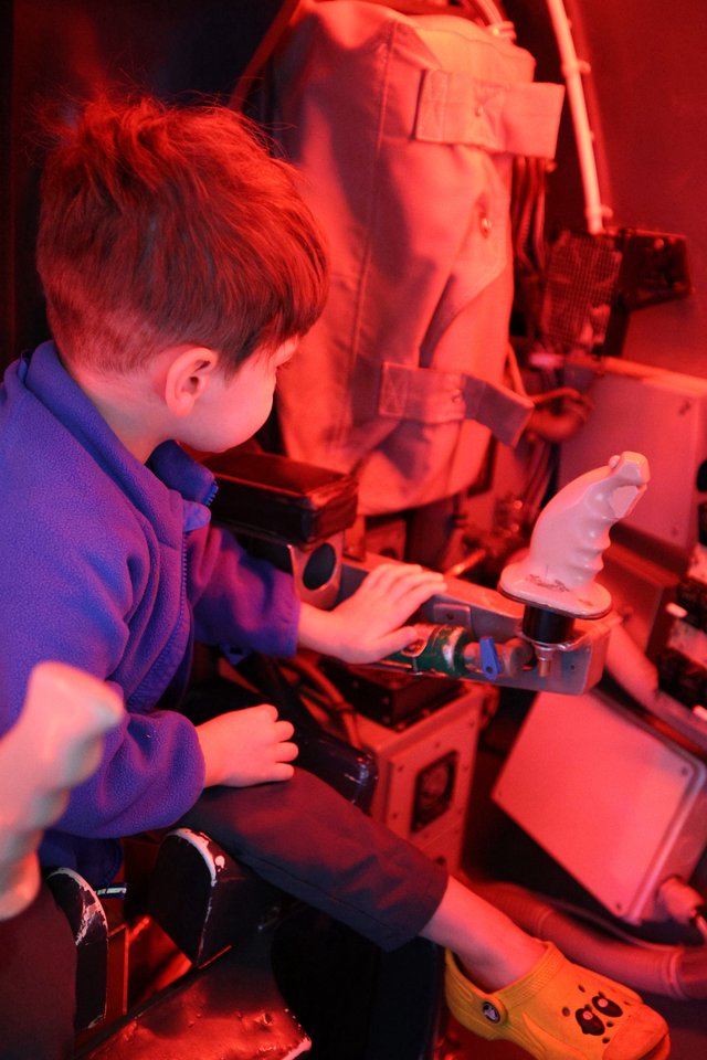 Young Student Exploring Science Under Red Light