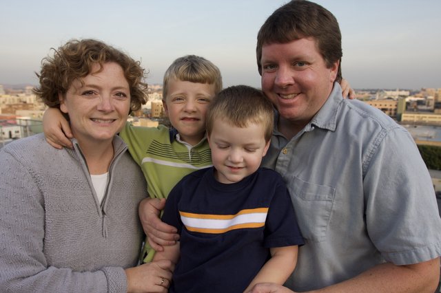 Family Portrait at Sunset Over City Skyline