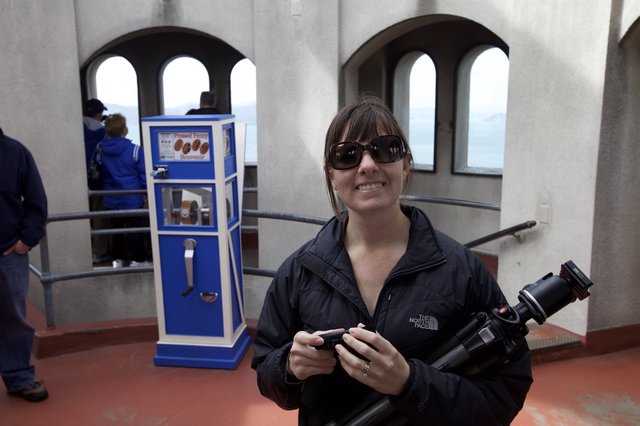 Photographer Smiling at Pressed Penny Souvenir Machine