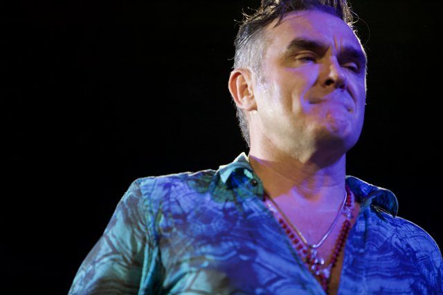 Morrissey: A Blue-Shirted Performer with Accessories