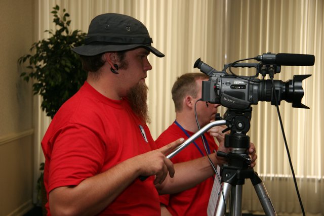 Red Shirted Photographer with Tripod