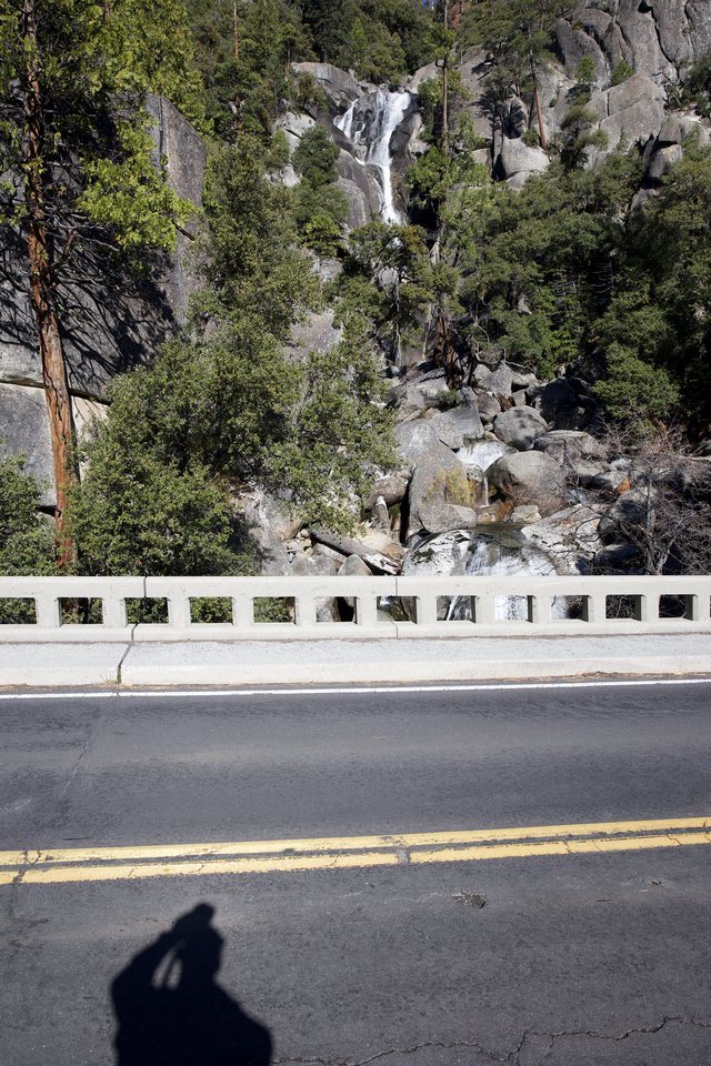 Mountain Highway with Cascading Waterfall Vista