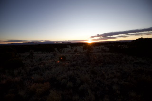 Desert Sunset Over Distant Mountain Range