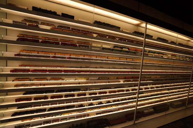 Extensive Model Train Collection Display with Illuminated Shelving