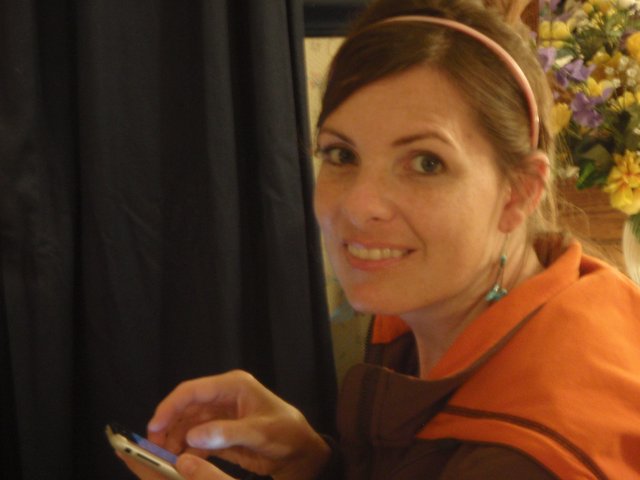 Woman Smiling with Phone at Wedding Reception